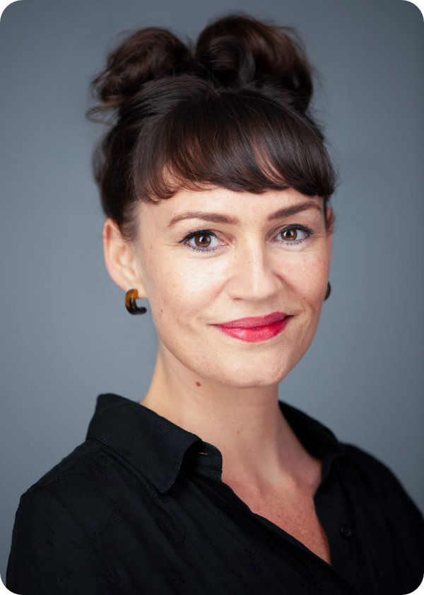 a person smiling with their hair up